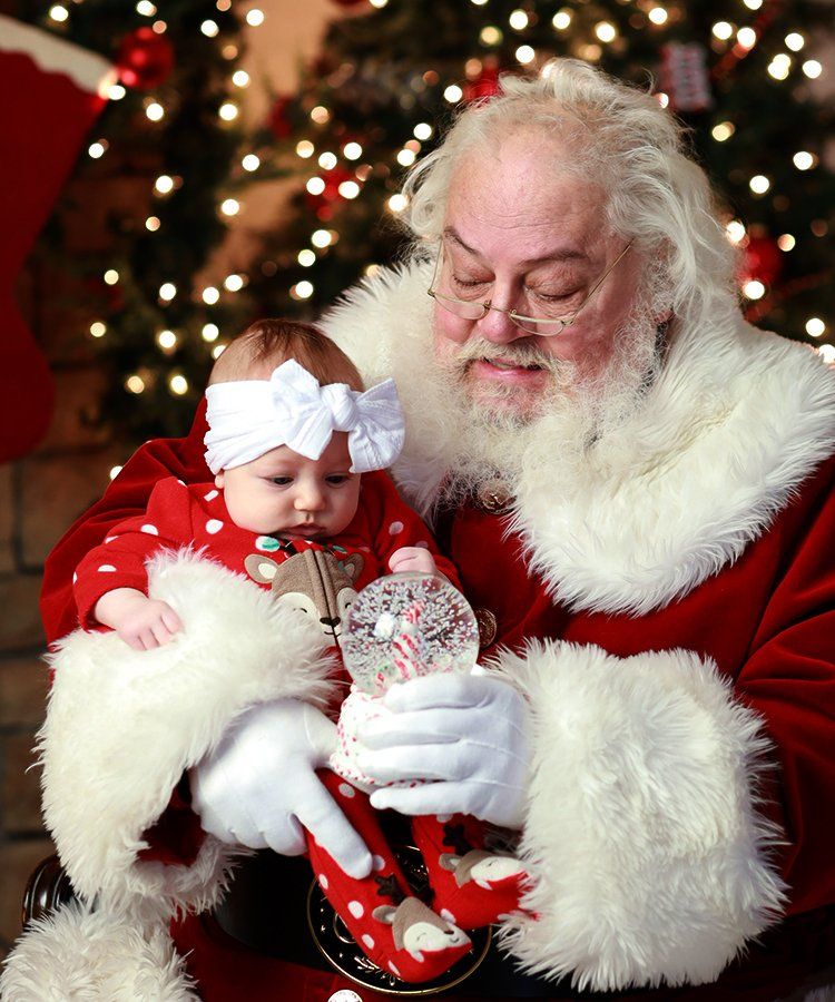 Santa holding a baby for photo