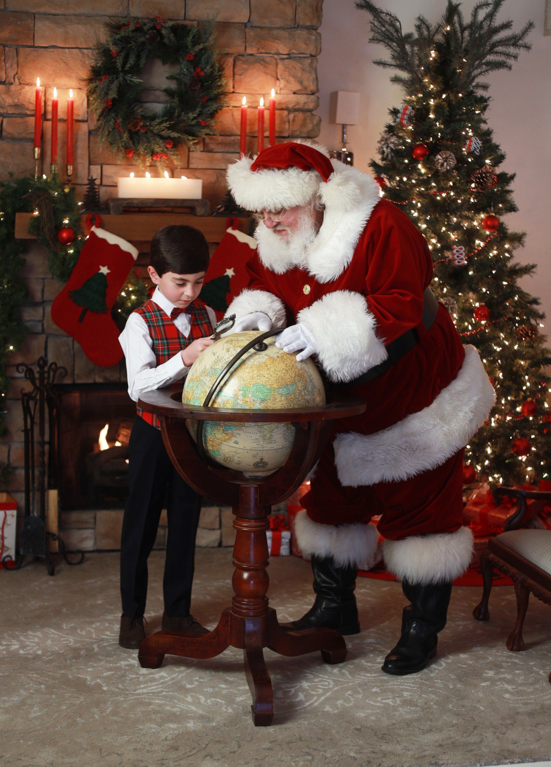 Santa and child exploring globe