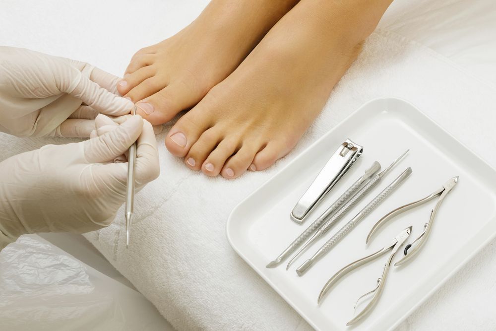 Pedicurist Trimming Toenails With Tools on a Tray — Aspire Beauty & Nails in Wagga Wagga, NSW