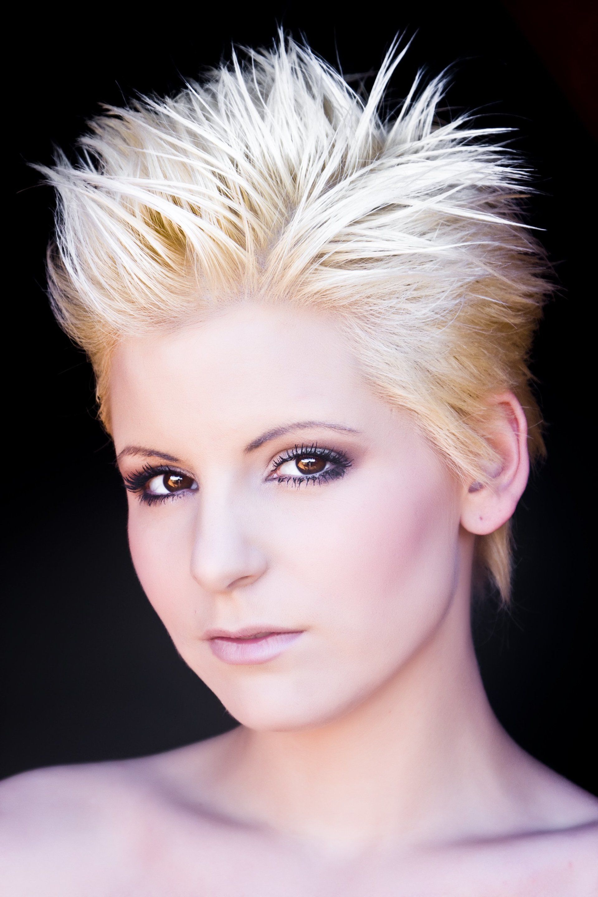 A close up of a woman 's face with short blonde hair