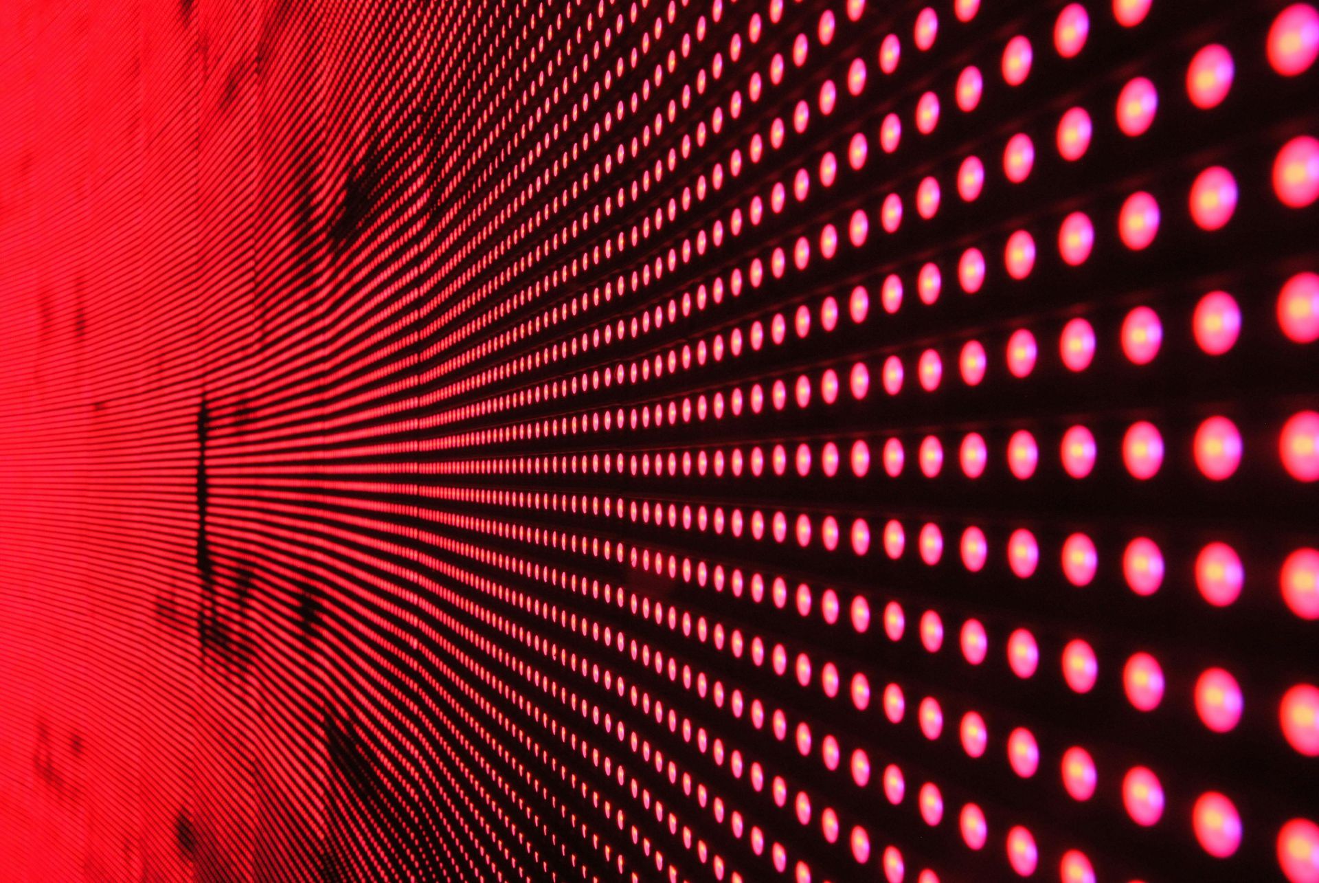 Red LED lights on a grid stretching away from the viewer