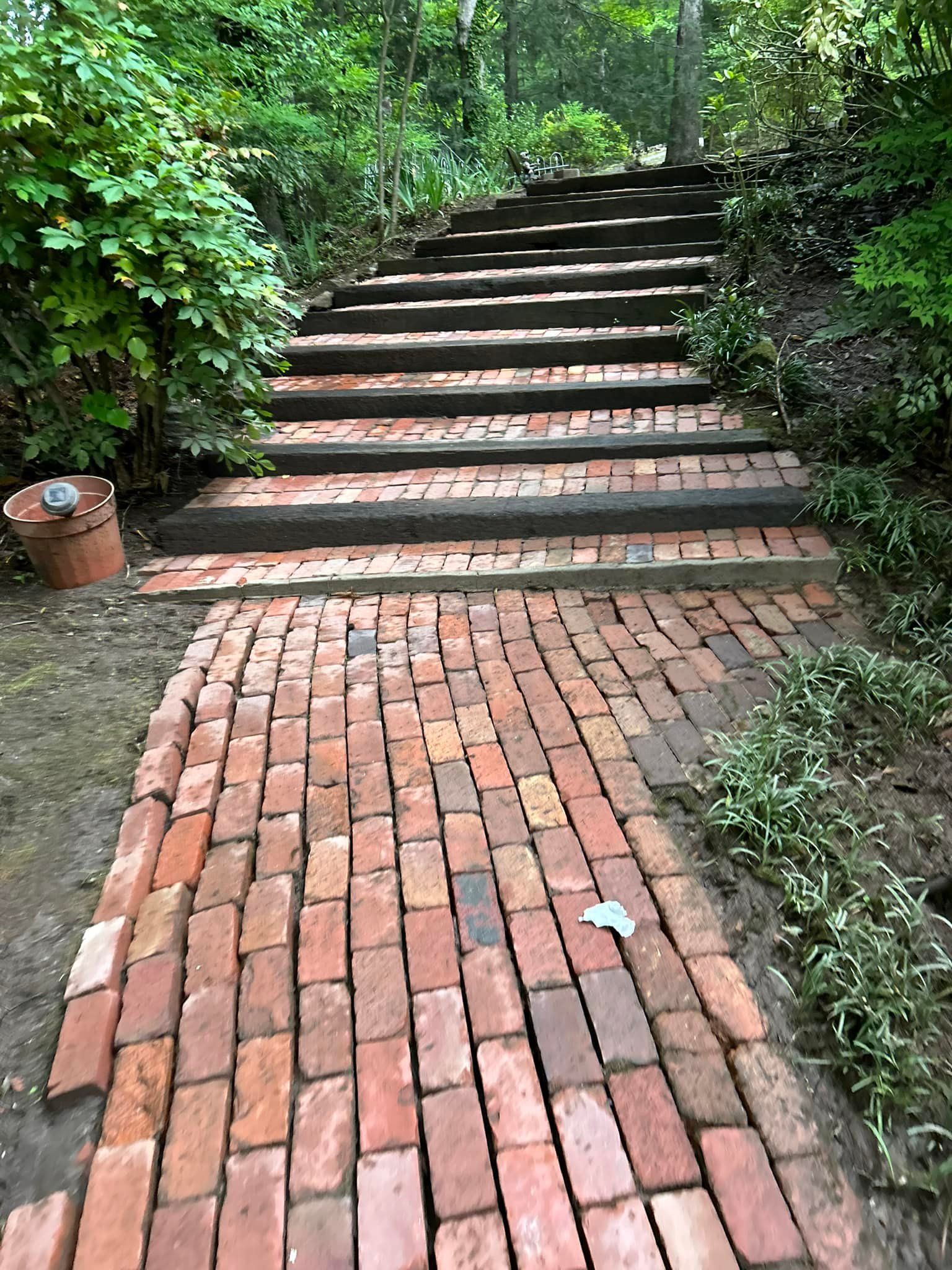 Brick garden steps rising through lush greenery along a shaded path
