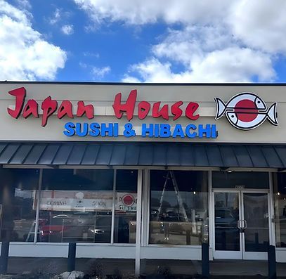 Colored logo of Japan House with torii gate and water color background.