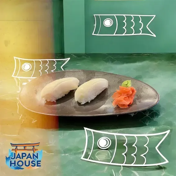 Sushi nigiri on a dark plate with garnish, over green and yellow background with Japan House logo