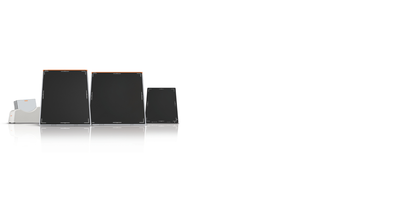 Three black and gold electrical enclosures of varying sizes are lined up on a white surface, slightly reflected below.