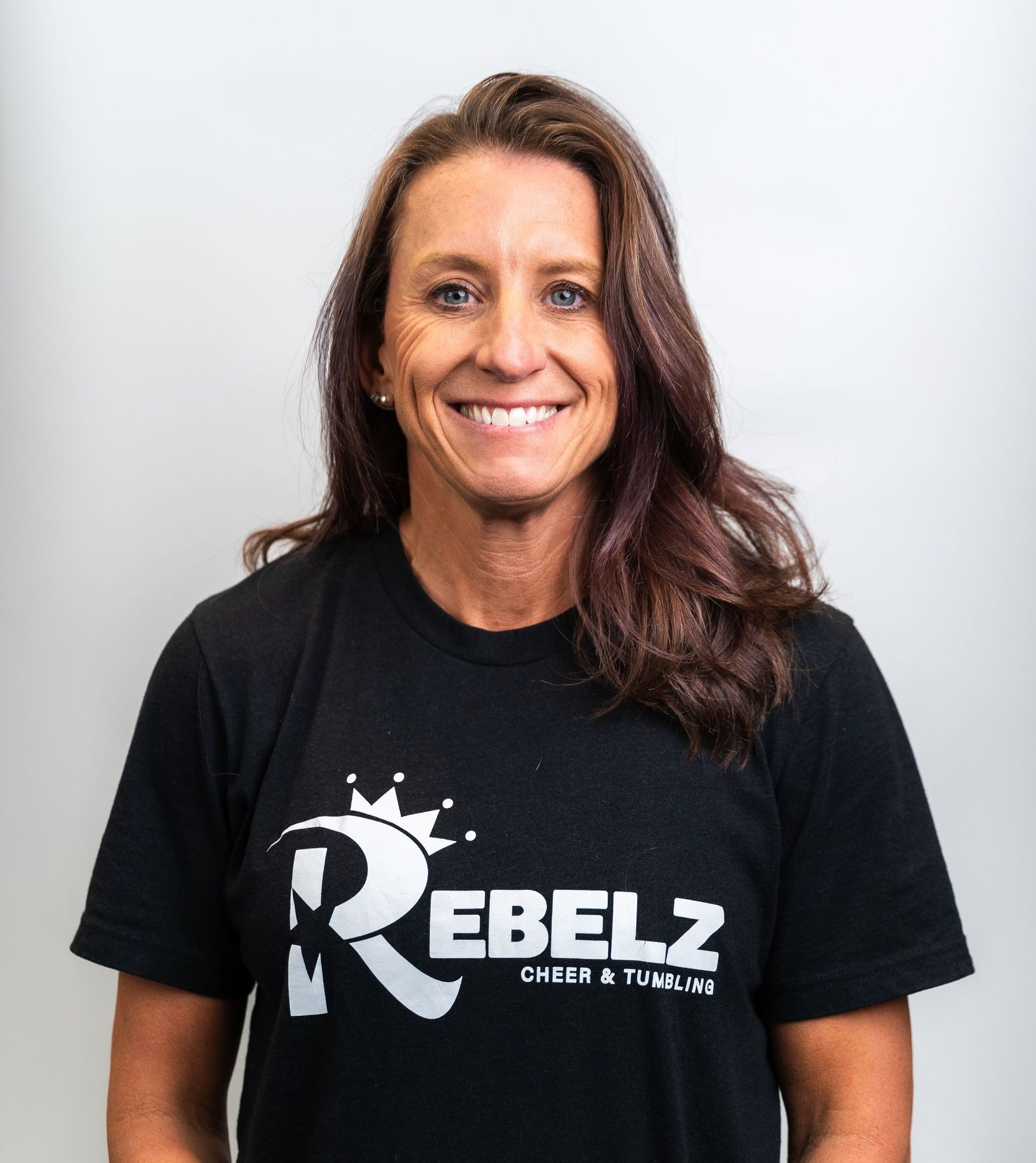 A woman in a black shirt is smiling for the camera.