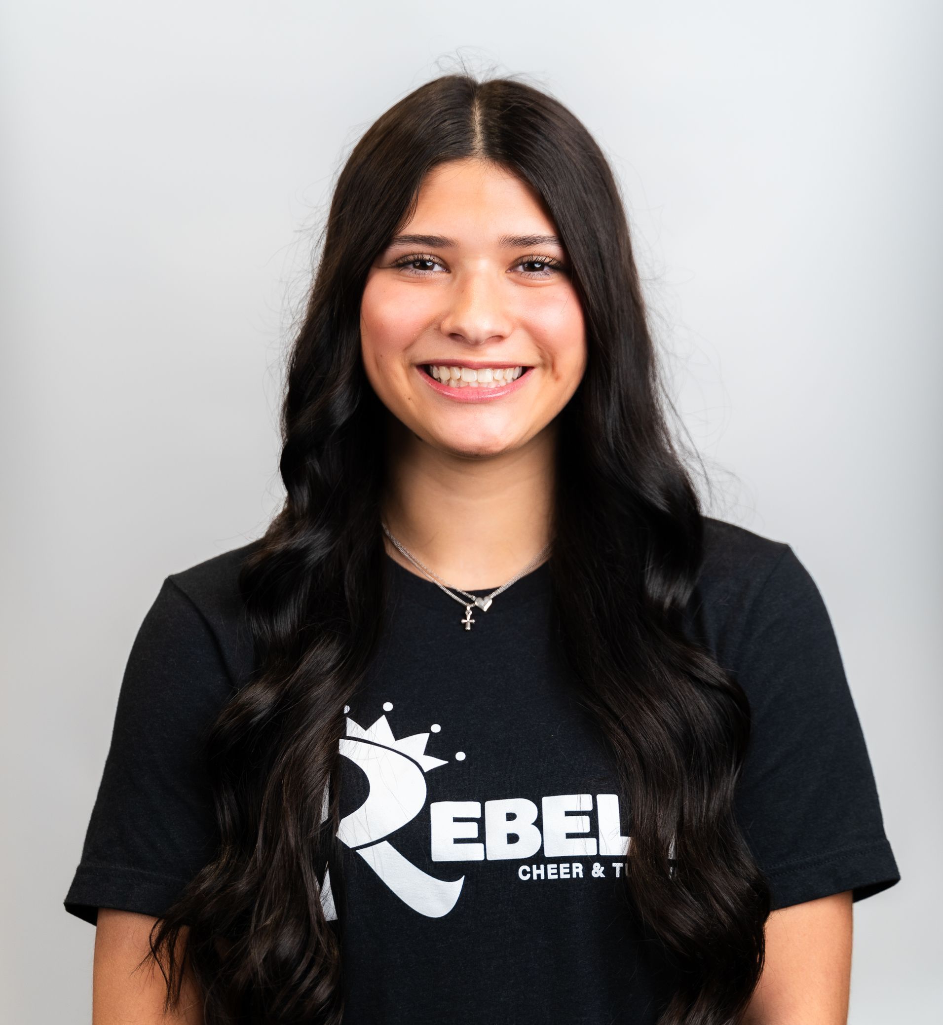 A woman wearing a black shirt with the letter r on it