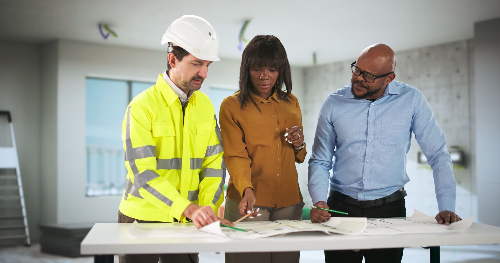 Young Engineer And Contractor Discussing House Plans With Couple. Young Engineer And Contractor Discussing House Plans With Couple.