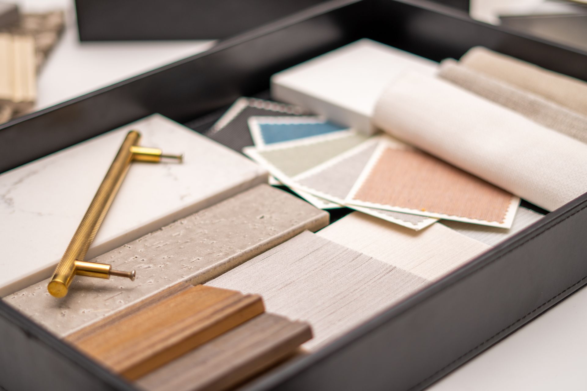 Remodeling design table with color palette, flooring and fabric samples for a renovation project