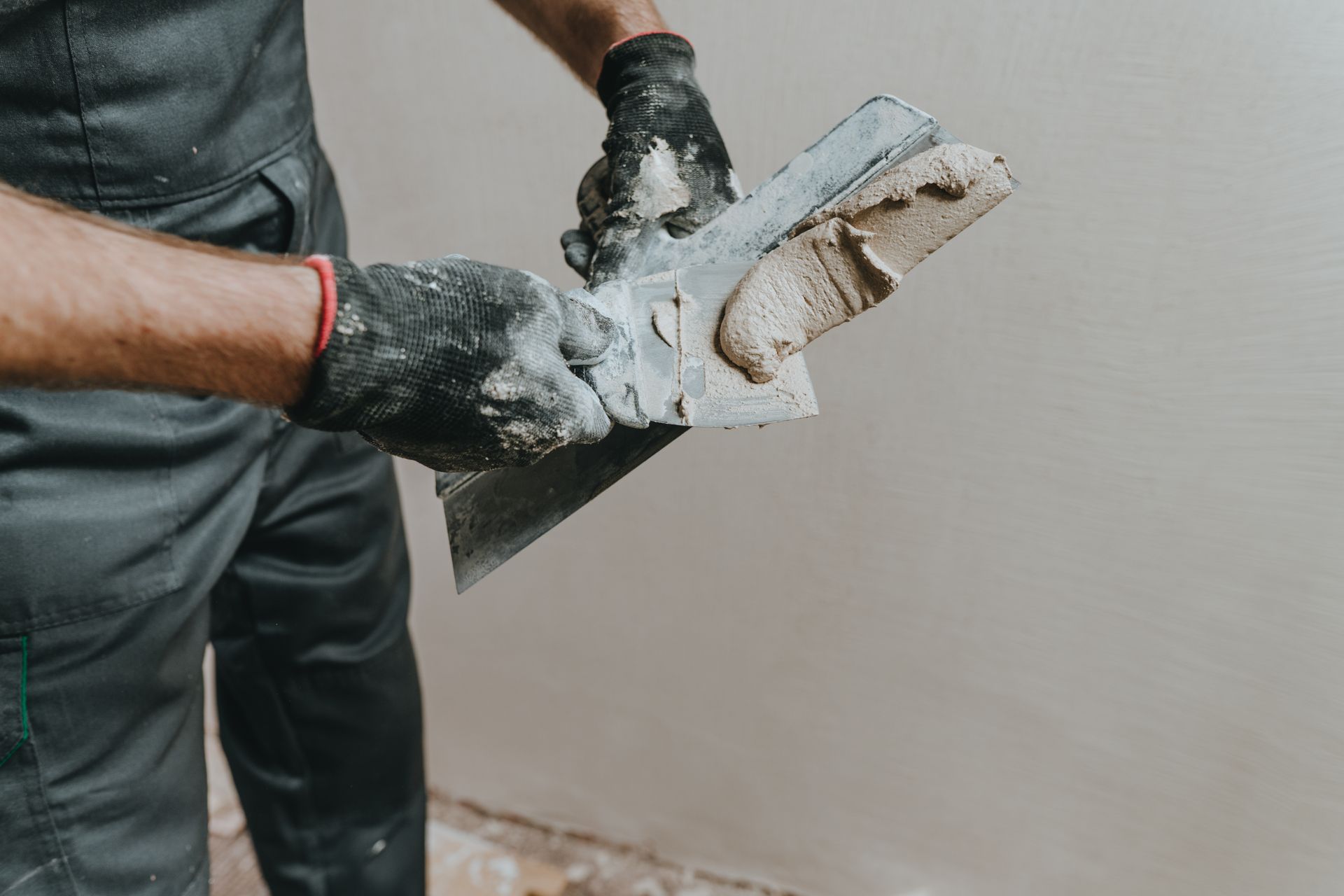 remodeling contractor applying plaster to interior walls