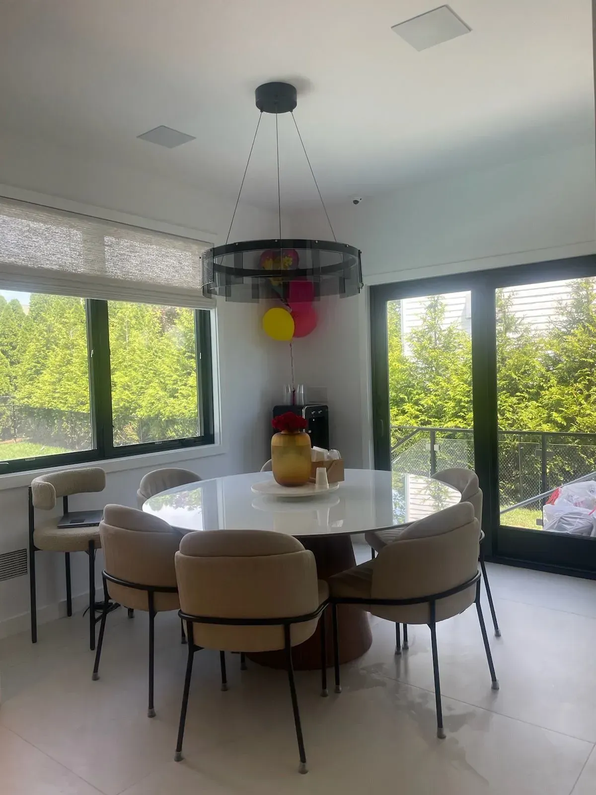A dining room with a round table and chairs