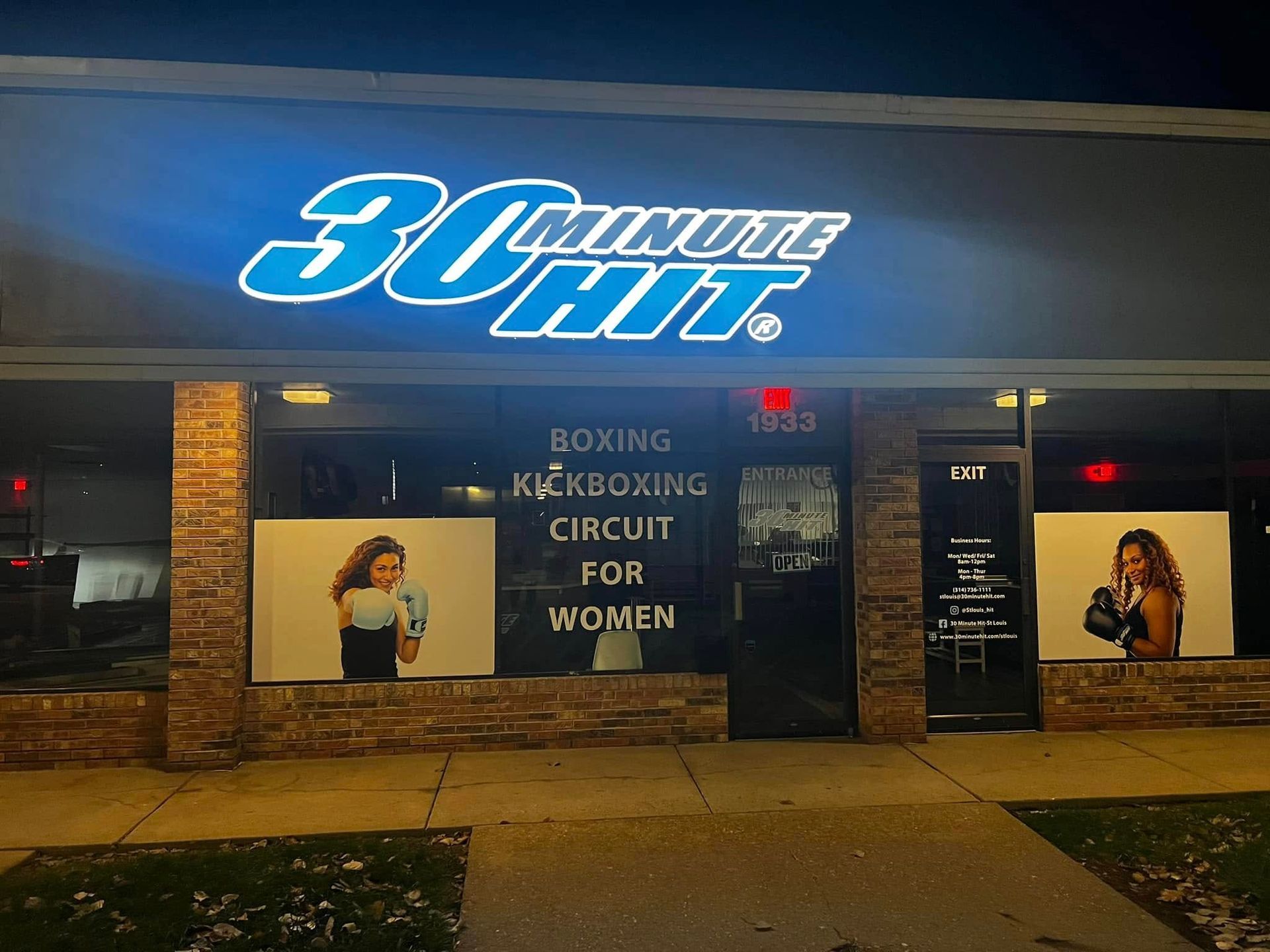 30 Minute Hit gym storefront at night with blue neon sign and boxing kickboxing circuit banner