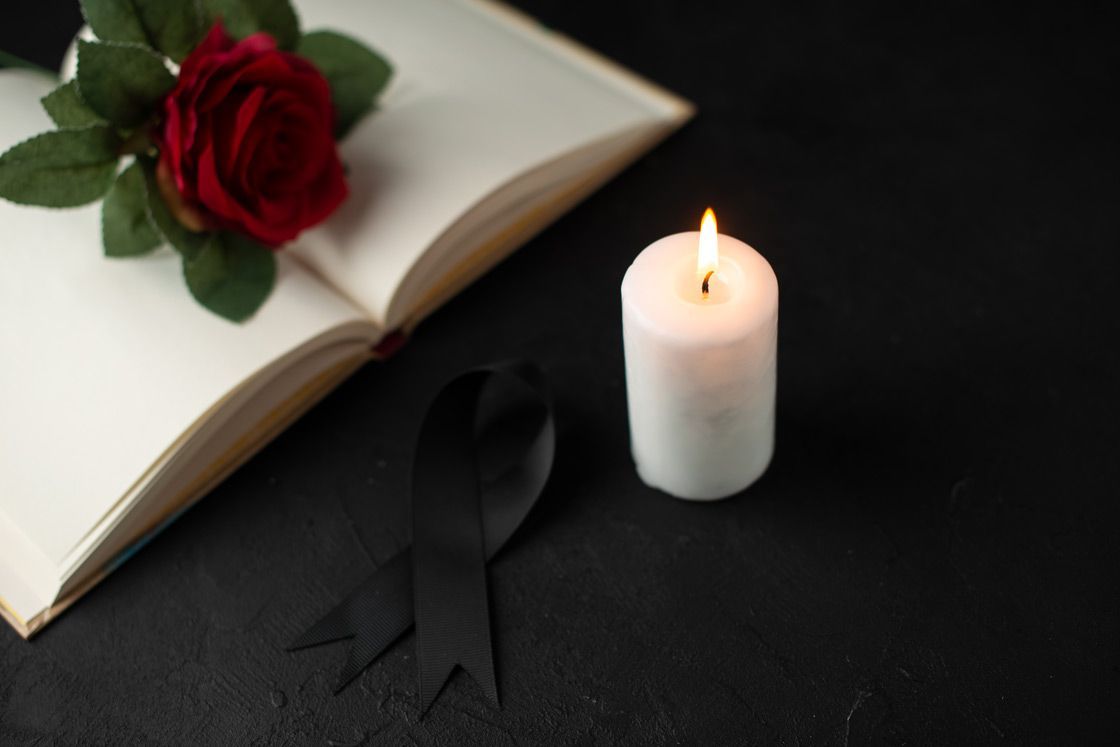 red rose with open book and candle, funeral homes Phoenix, AZ