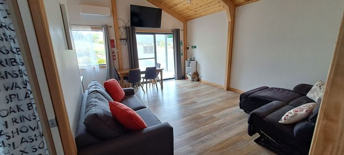 A living room with a couch , chair and television