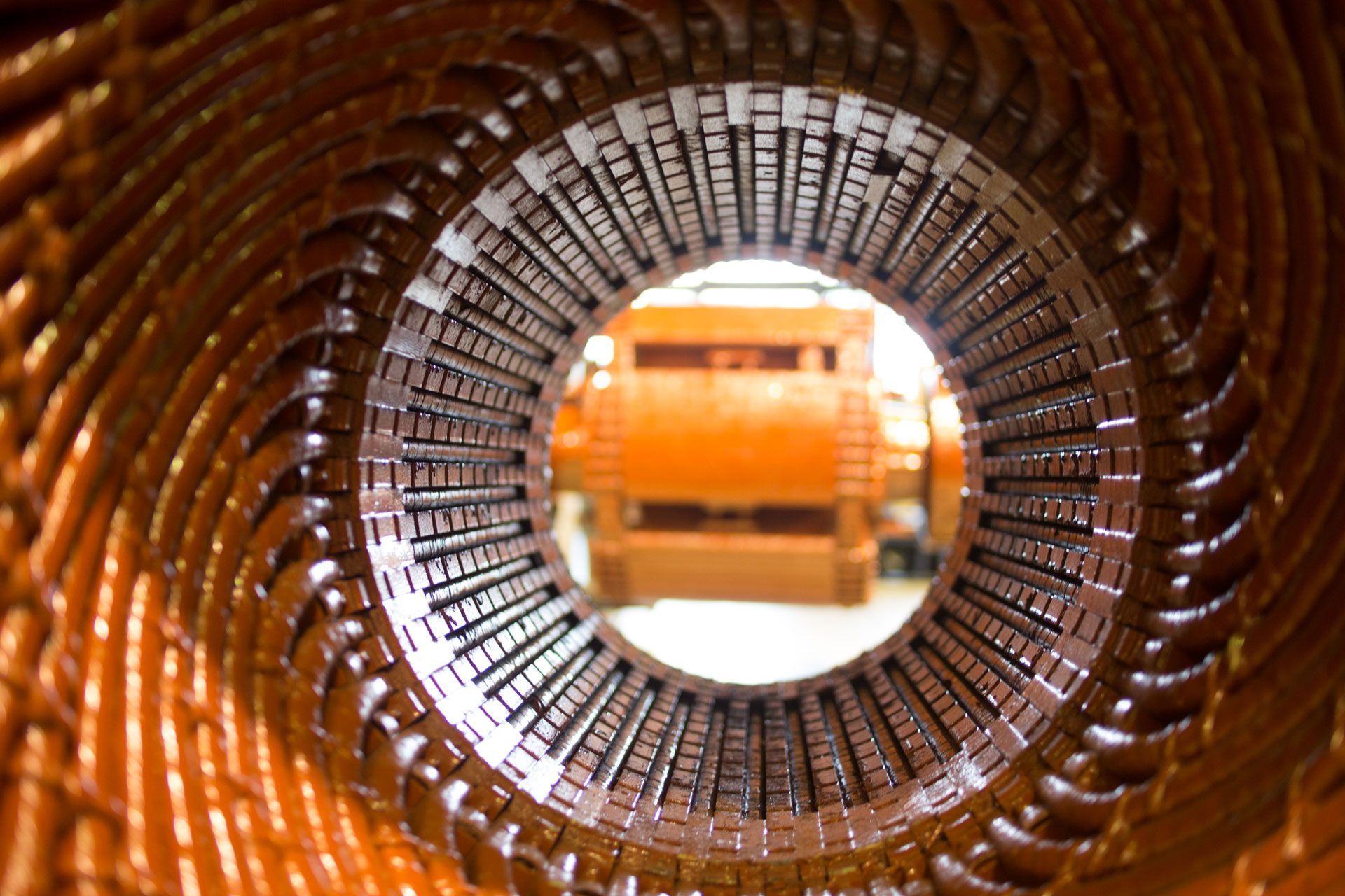 A close up of the inside of a machine with a motor in the background