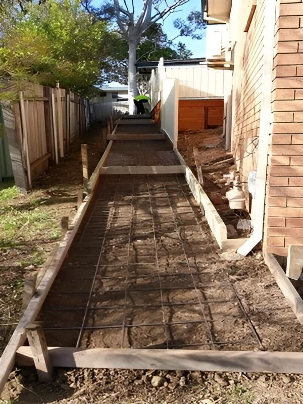 A Wooden Fence Along The Side Of A Road — Concept Concreting NSW In Figtree, NSW