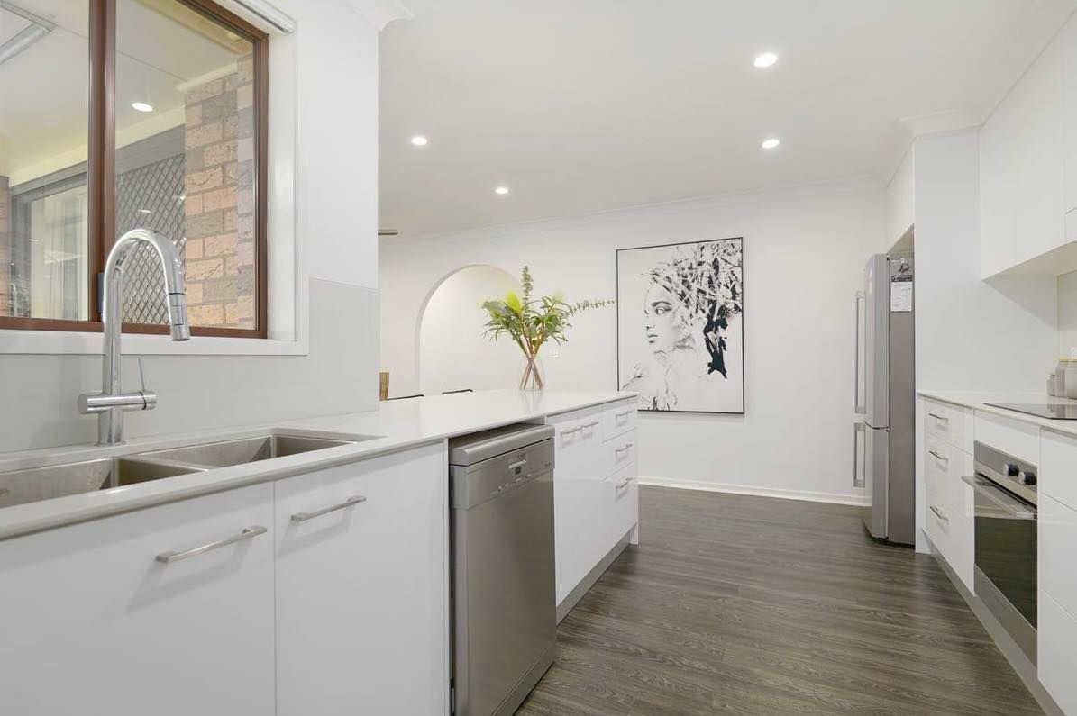 A Kitchen With White Cabinets and Stainless Steel Appliances — Hunter Kitchen King In Rutherford, NSW