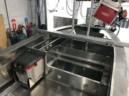 A Stainless Steel Boat is Being Built in a Garage — Boyd's Fabrications In Gordonvale, QLD