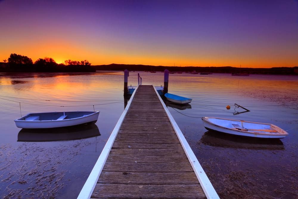 Three Boats Are Docked at a Dock at Sunset — Boyd's Fabrications In Portsmith, QLD 