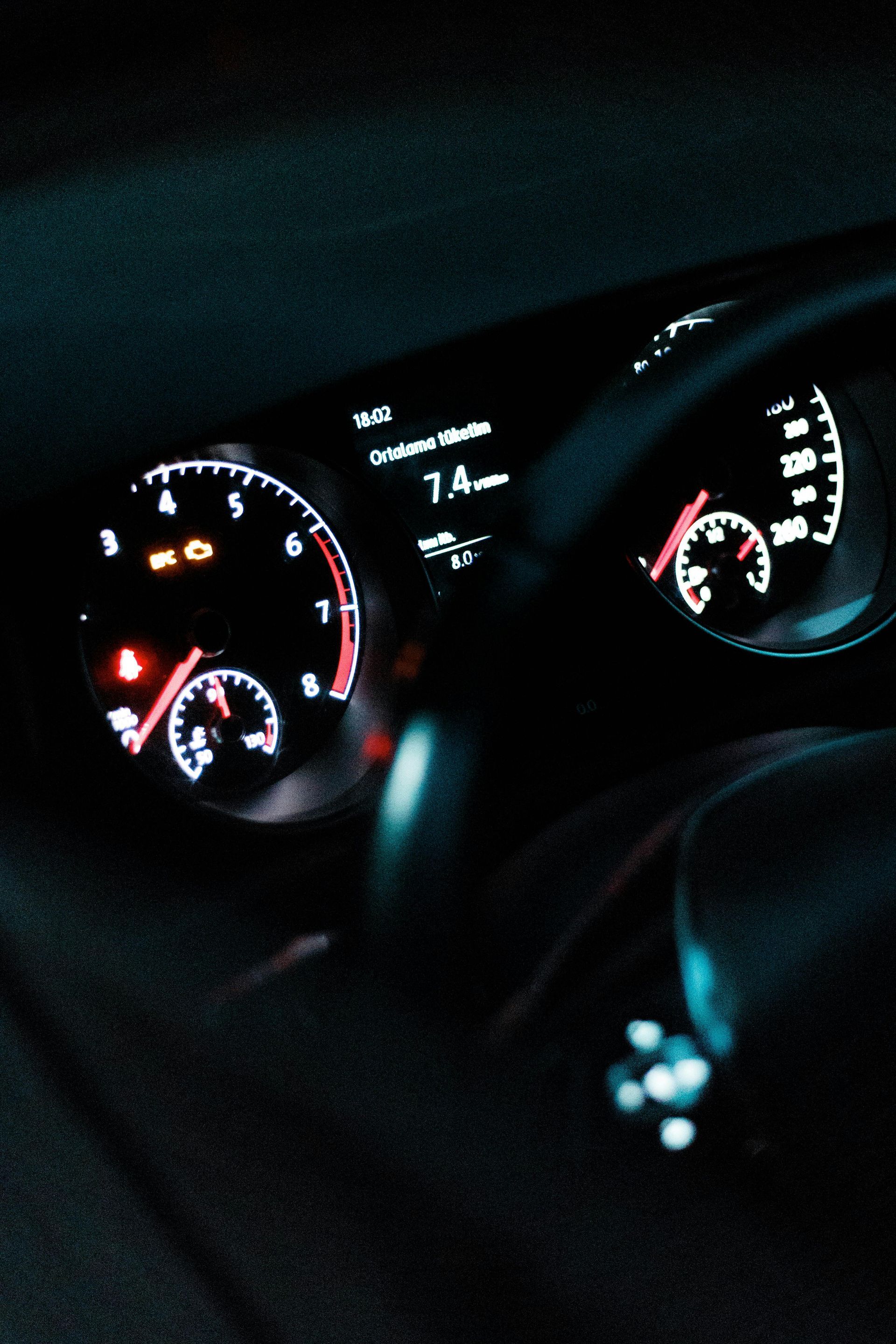 A close up of a car dashboard with a speedometer that reads 7.4