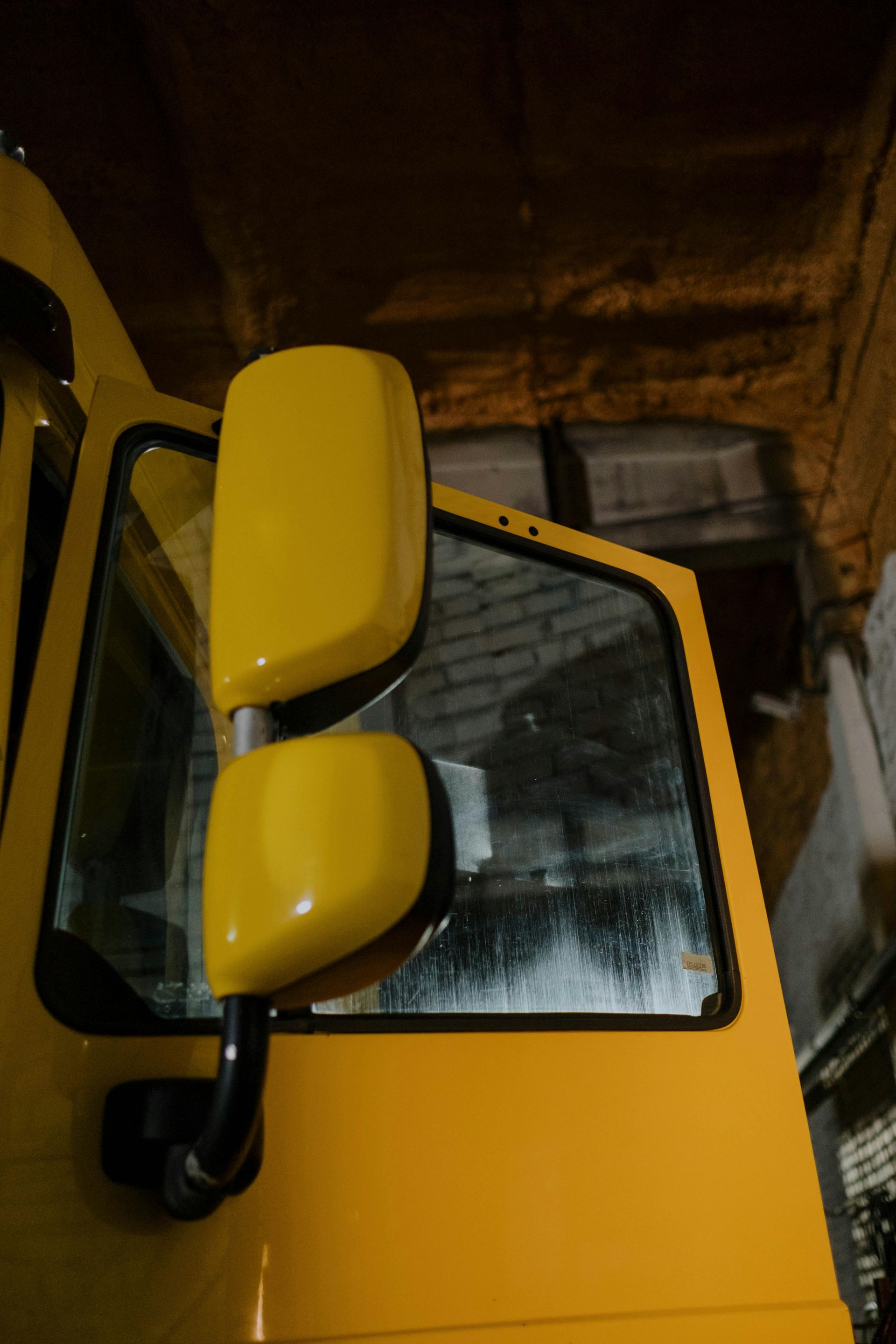 A yellow car with two yellow side mirrors on it