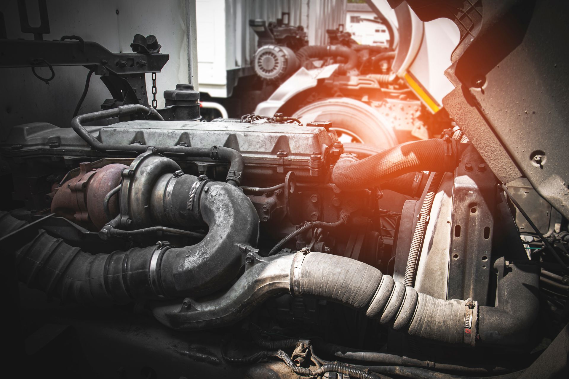 A close up of a truck engine with the hood open.