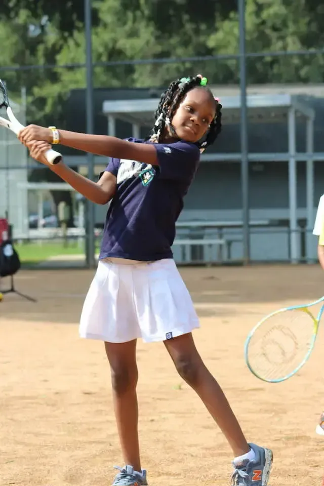 young woman swing Tennis racket 