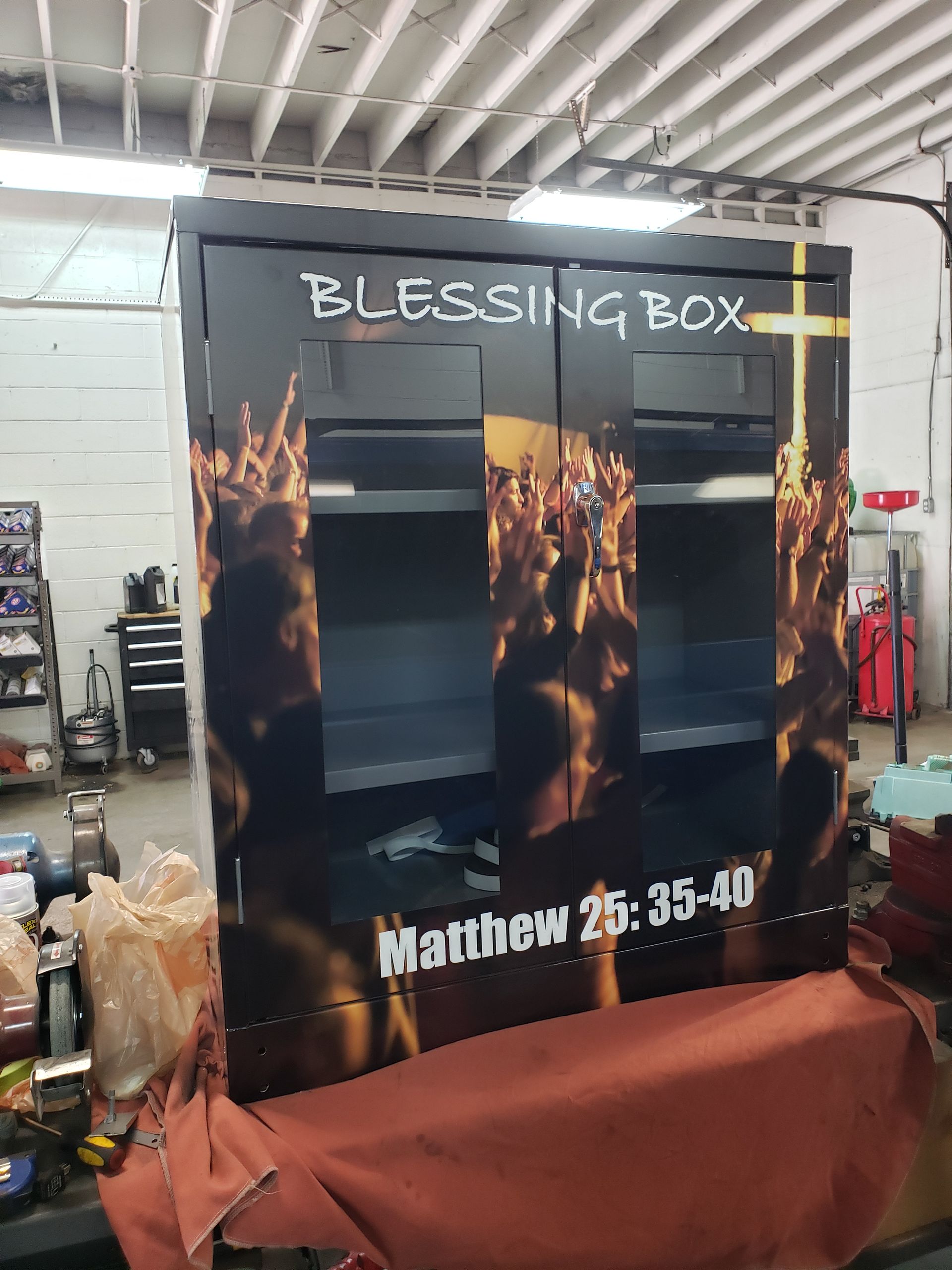 Black Blessing Box with crowd graphic and Matthew 25:35-40 quote.