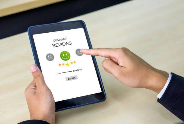 Someone leaving a positive business review on a tablet
