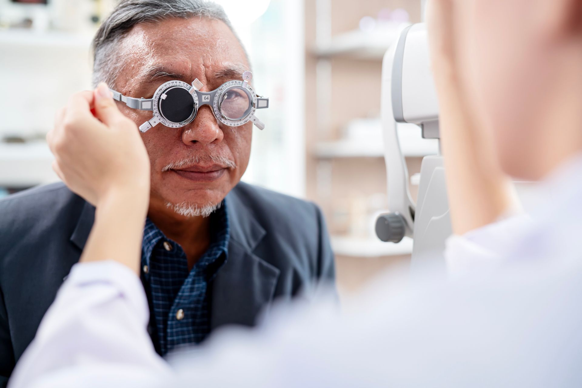 A man is getting his eyes checked by an ophthalmologist.