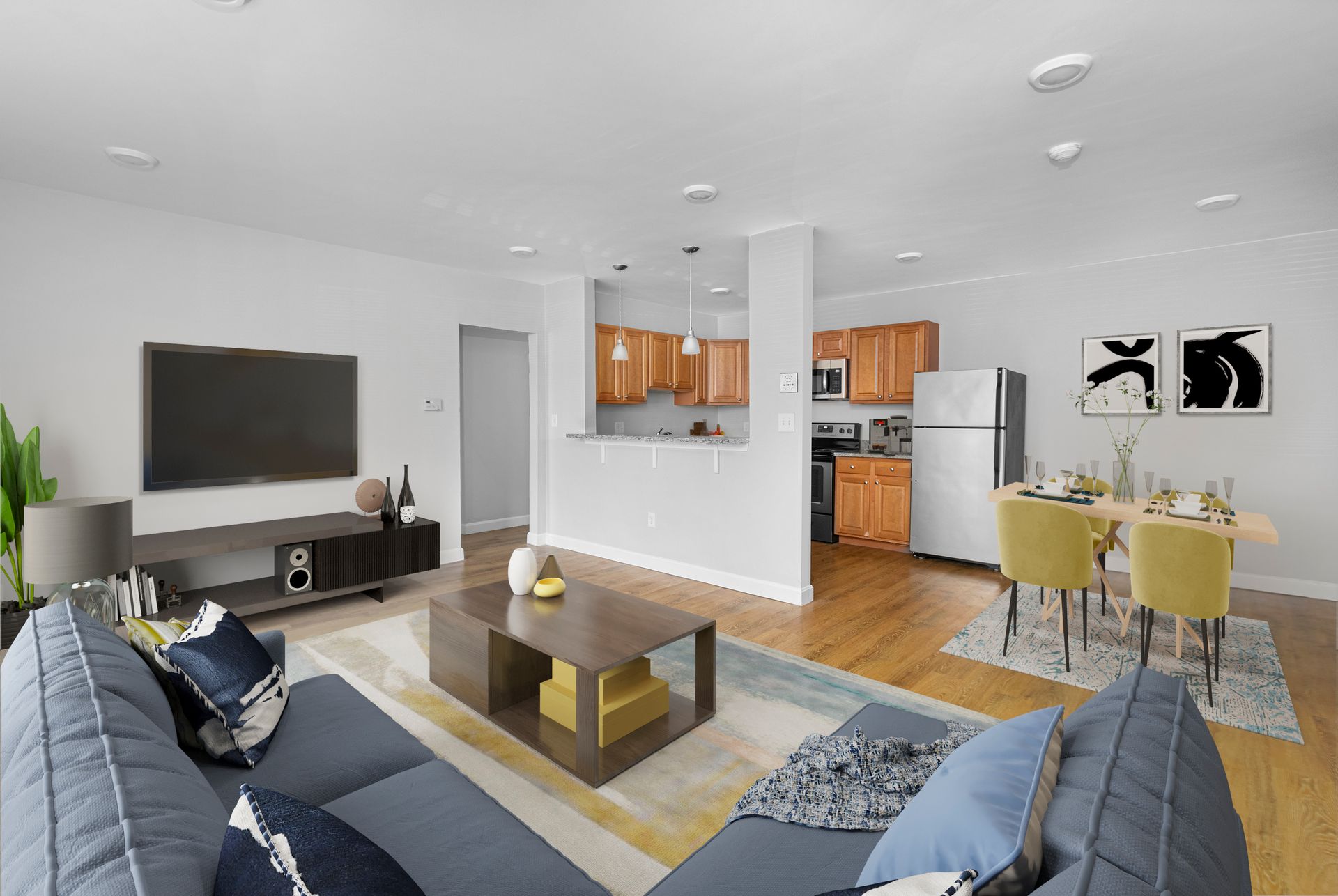Furnished living room with dining area and open kitchen at Waltham Overlook Apartments in Waltham, MA.
