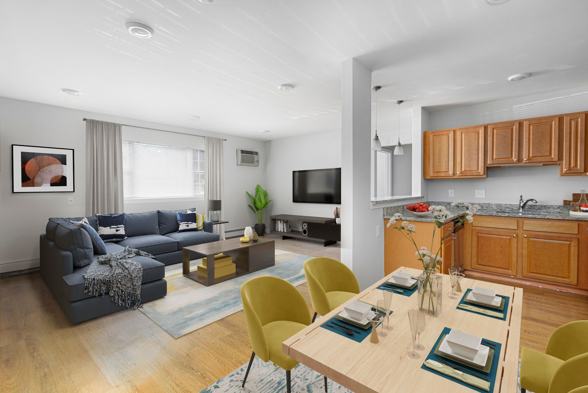 Open-concept living room and kitchen with breakfast bar and dining area at Waltham Overlook Apartments in Waltham, MA.