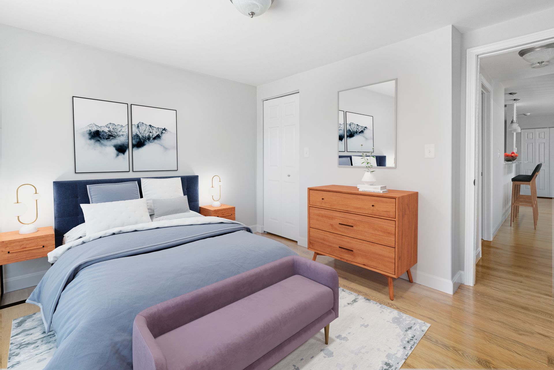Bedroom with wood-style flooring, dresser, and closet at Waltham Overlook Apartments in Waltham, MA.