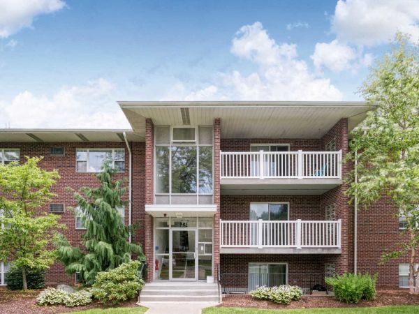 Exterior view of apartment building with private balconies at Waltham Overlook Apartments in Waltham, MA.