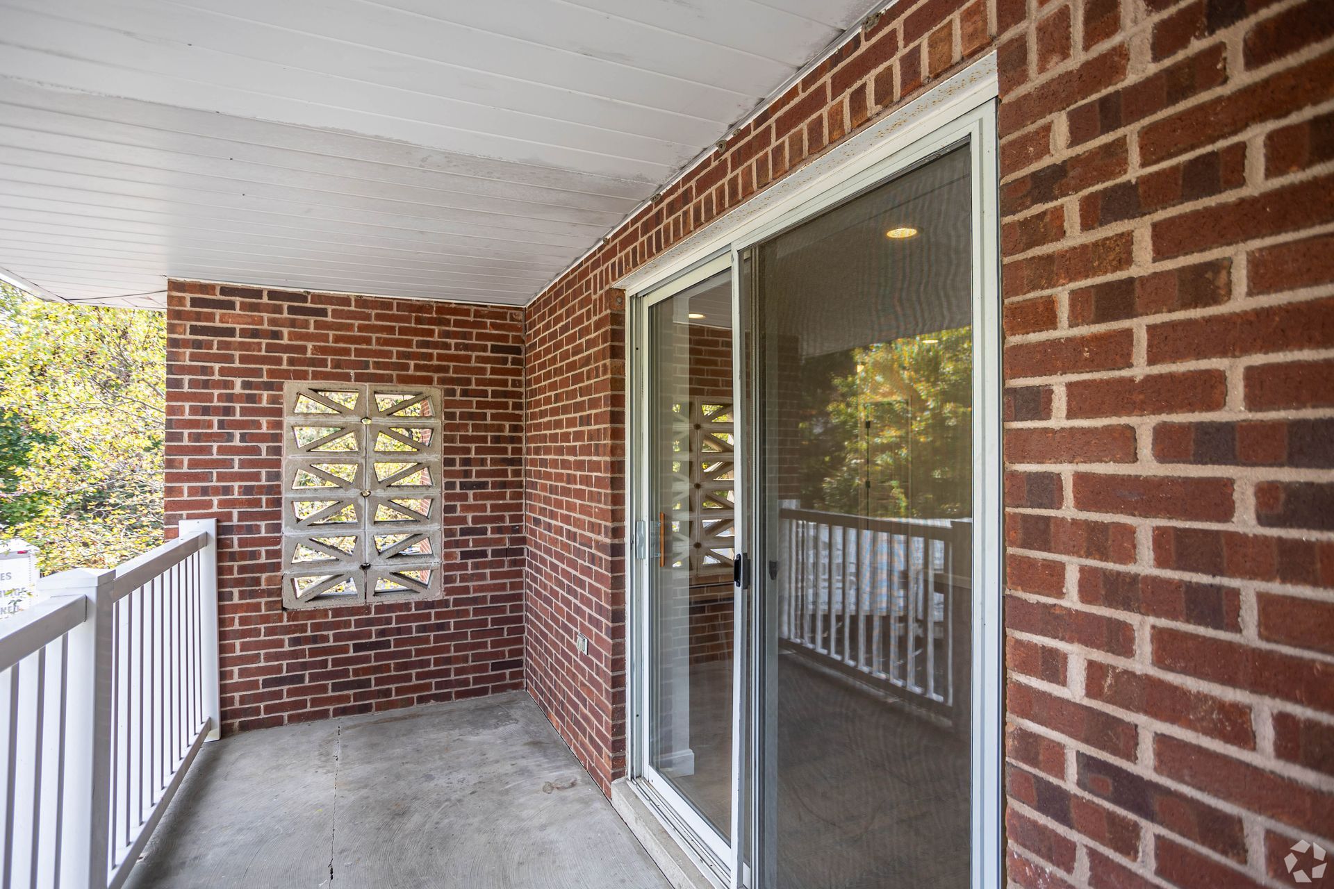 Private apartment balcony with brick walls at Waltham Overlook Apartments in Waltham, MA.