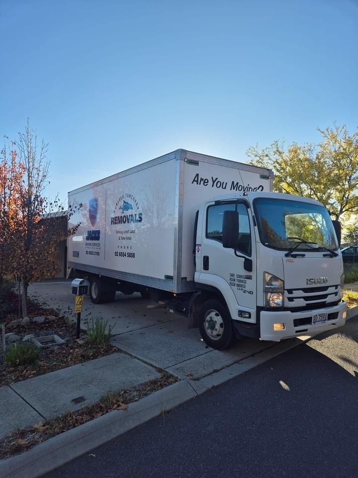A White Moving Truck is Parked on the Side of the Road — Forster Tuncurry Removals & Storage in Tuncurry, NSW