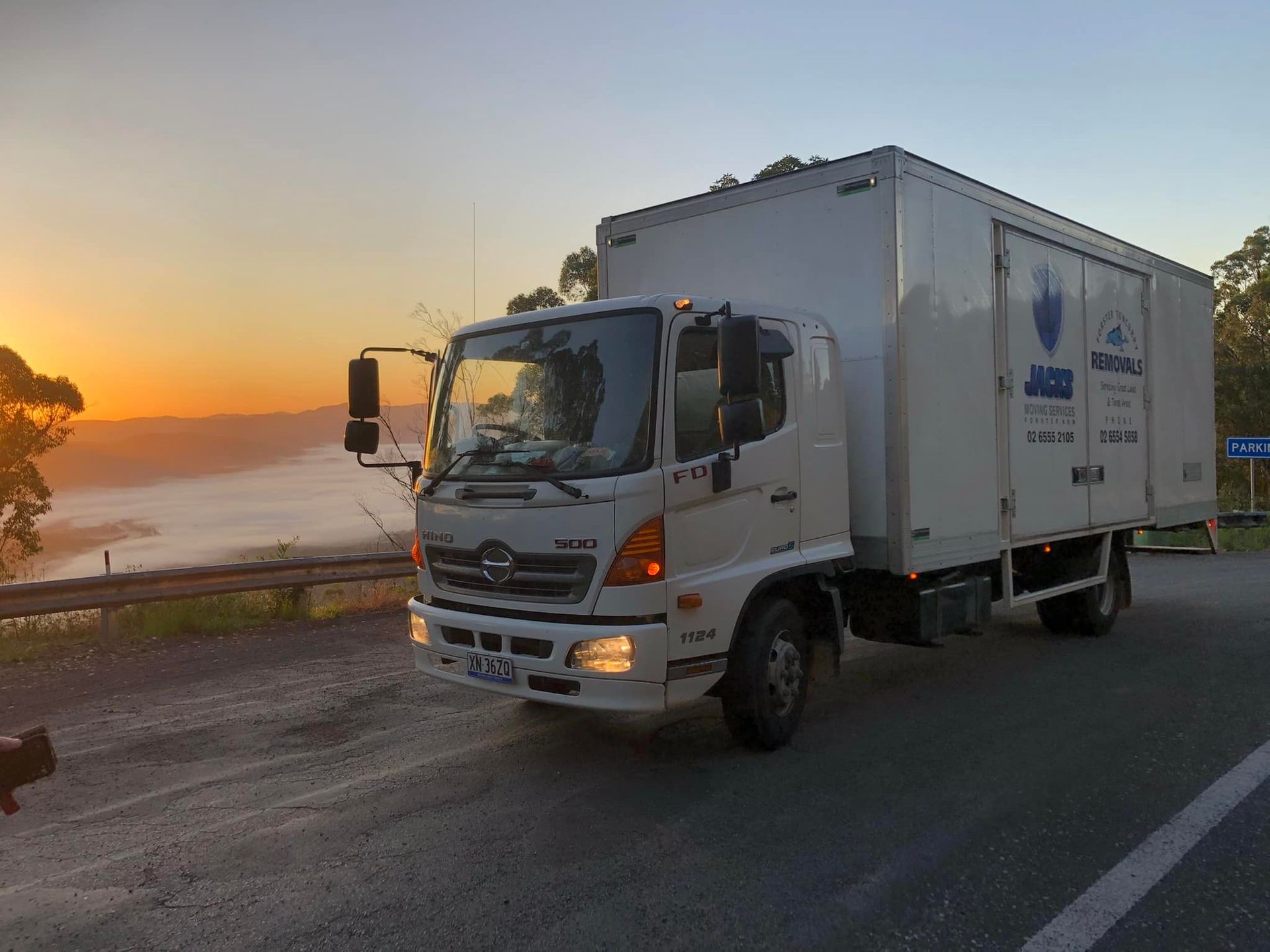 White Delivery Truck on a Road at Sunset, With Ocean — Forster Tuncurry Removals & Storage in Old Bar, NSW