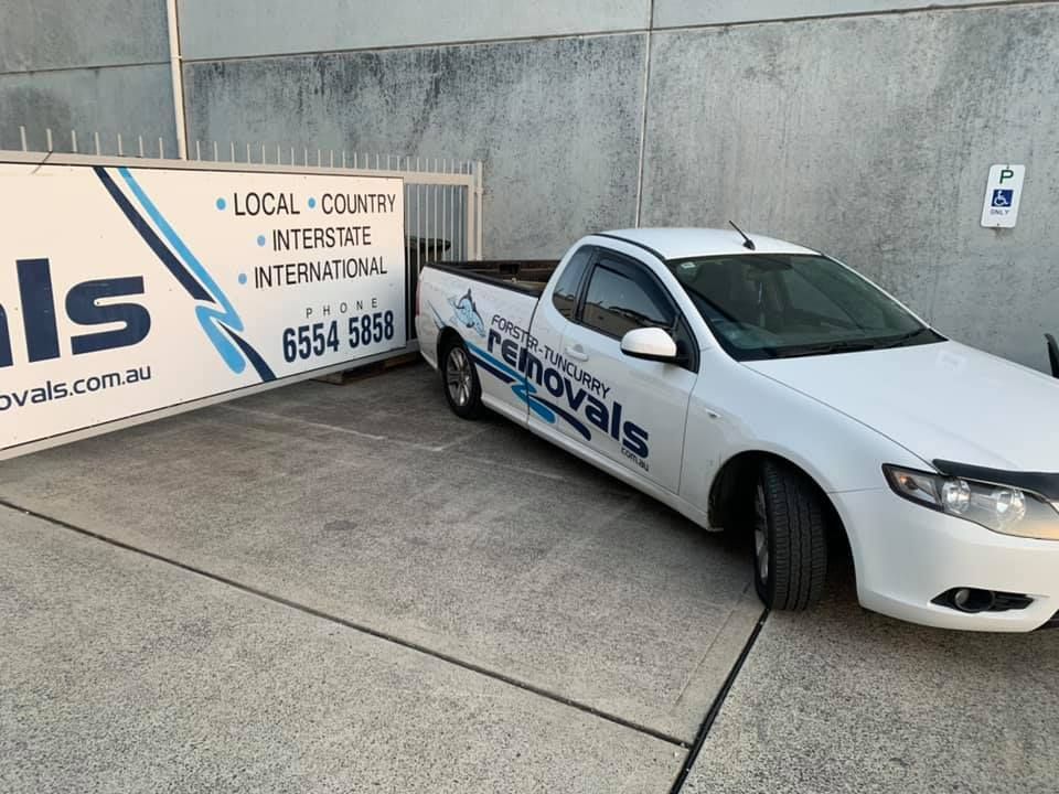 A White Truck Is Parked Next To A Sign That Says Removals — Forster Tuncurry Removals & Storage in Forster, NSW