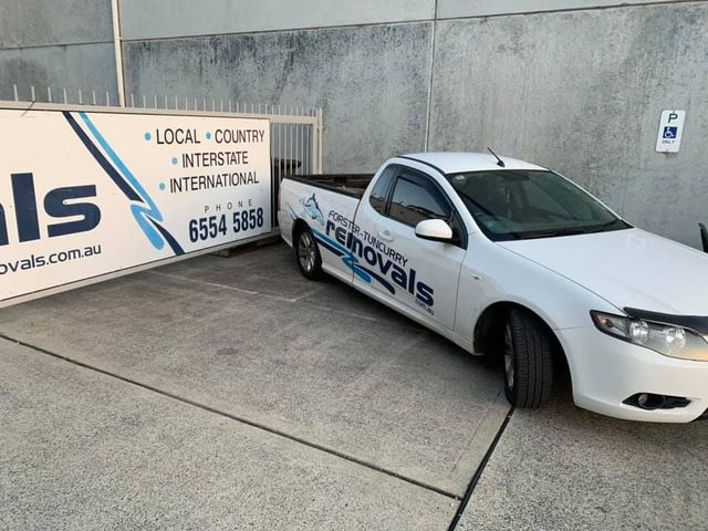 A White Truck is Parked Next to a Sign That Says Removals — Forster Tuncurry Removals & Storage in Tuncurry, NSW 