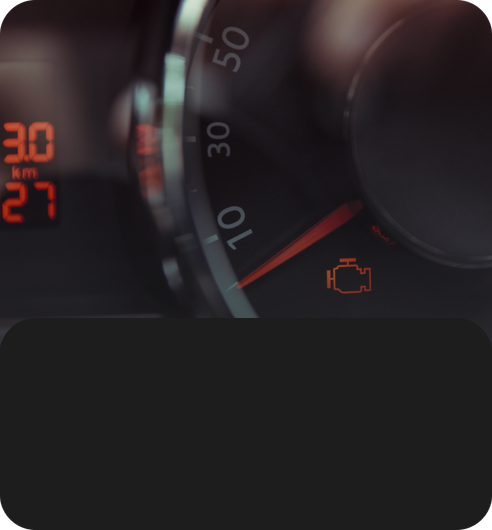 Blue and red manifold gauges held over car engine hoses and wiring | JB Auto Works