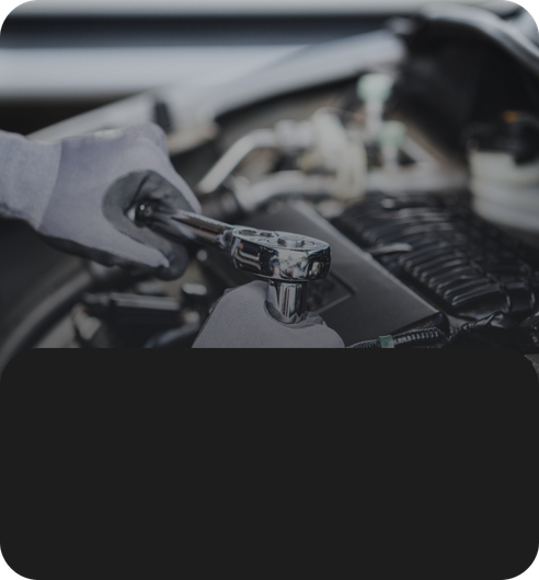 Car engine oil being poured under warm sunlight, with a hand holding the container. | JB Auto Works