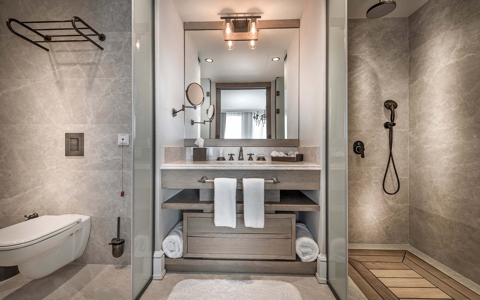 A bathroom with a toilet , sink , mirror and shower.