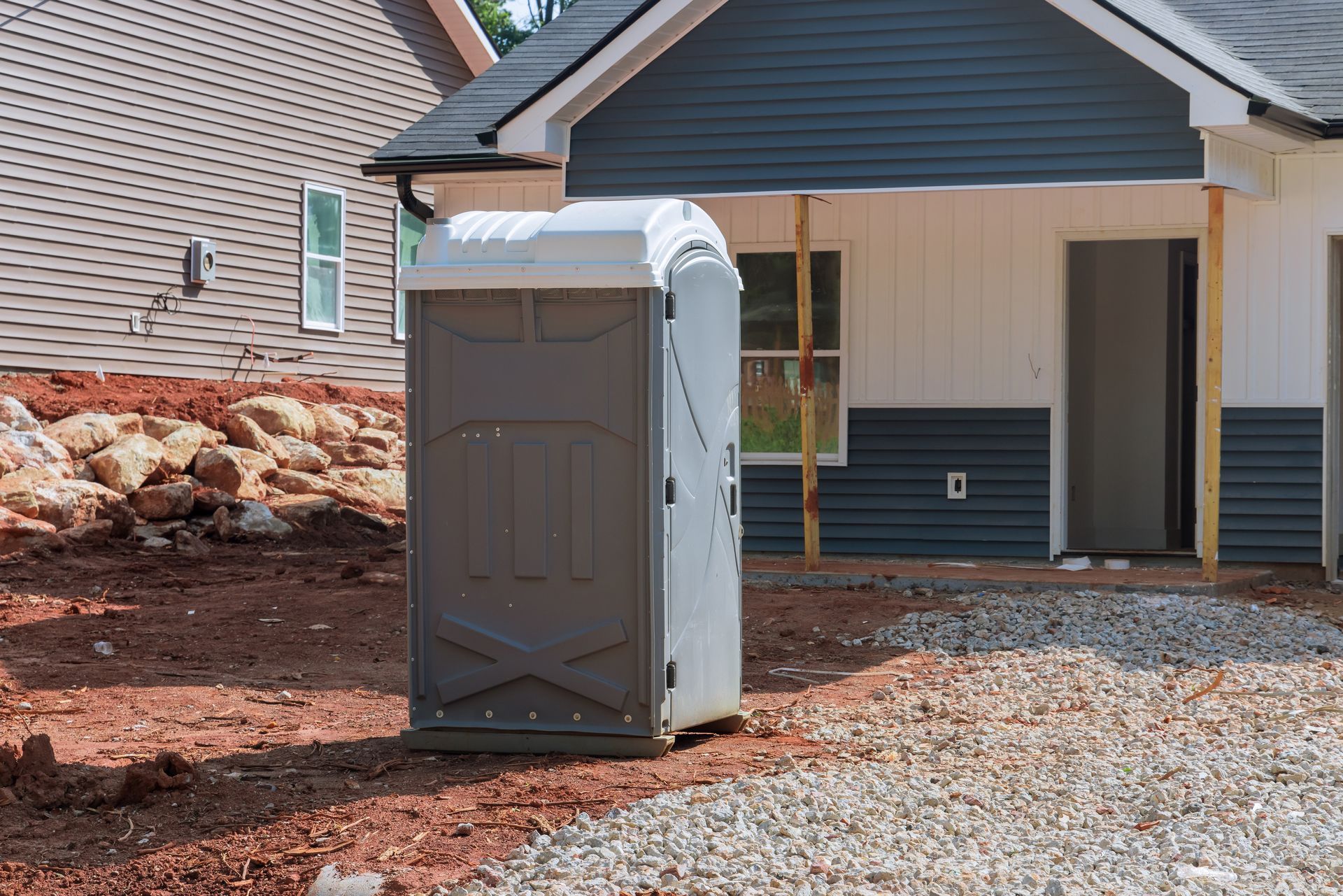 Portable restroom unit on-site for construction use.