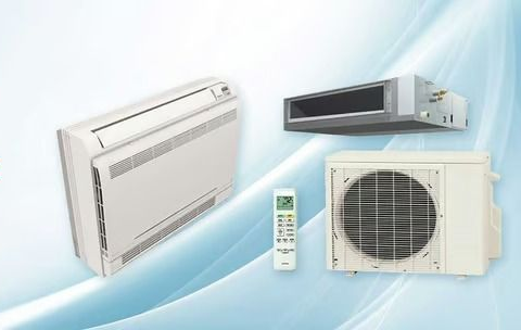 Three air conditioner units and a remote control on a light blue background