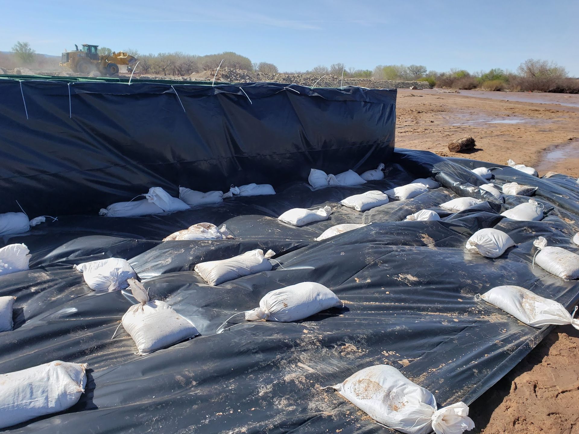 The HESCO Barrier was covered with plastic to prevent scouring and seepage from the flood water