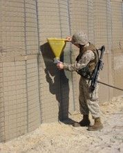 Cement slurry gun to protect hesco from UV degradation 