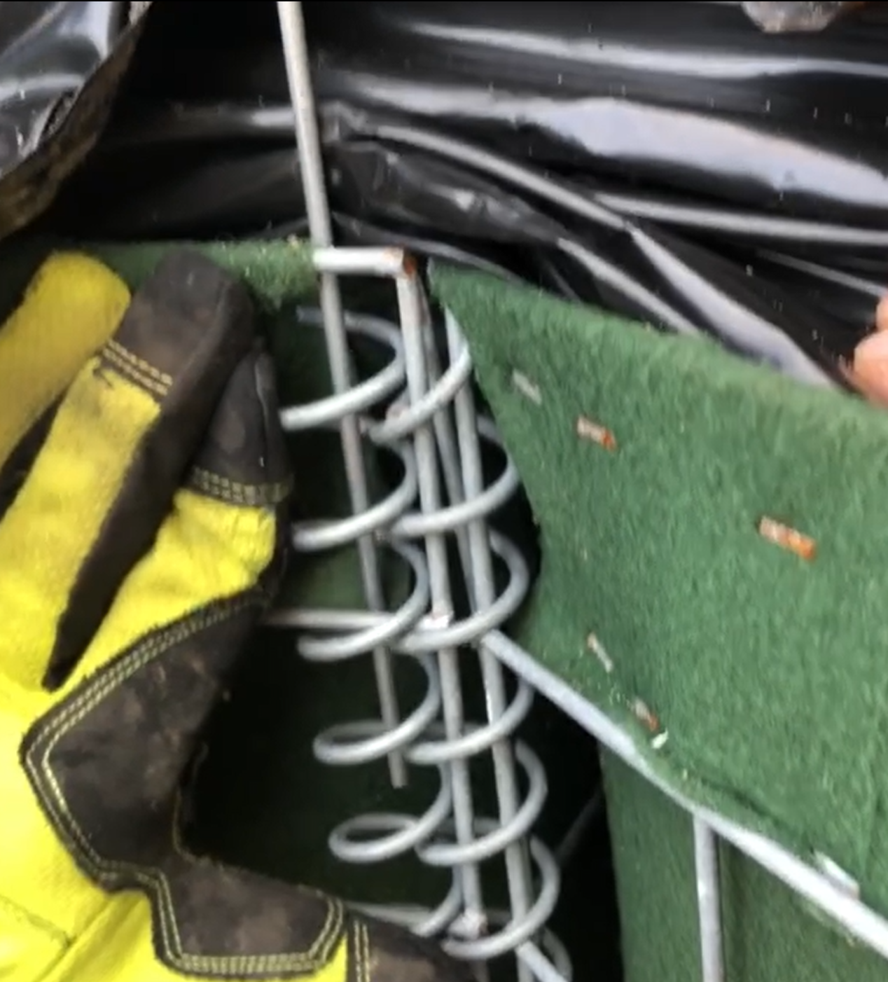 Connecting HESCO coils to the wire mesh of another HESCO panel for flood protection operations