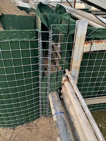 Flood Barrier Around Pipe Geotextile Tightening - HESCO Bastion
