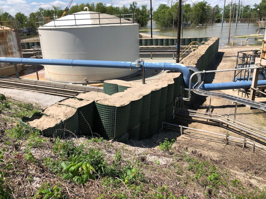 HESCO flood barrier ties into a levee with modified buttress cell visible