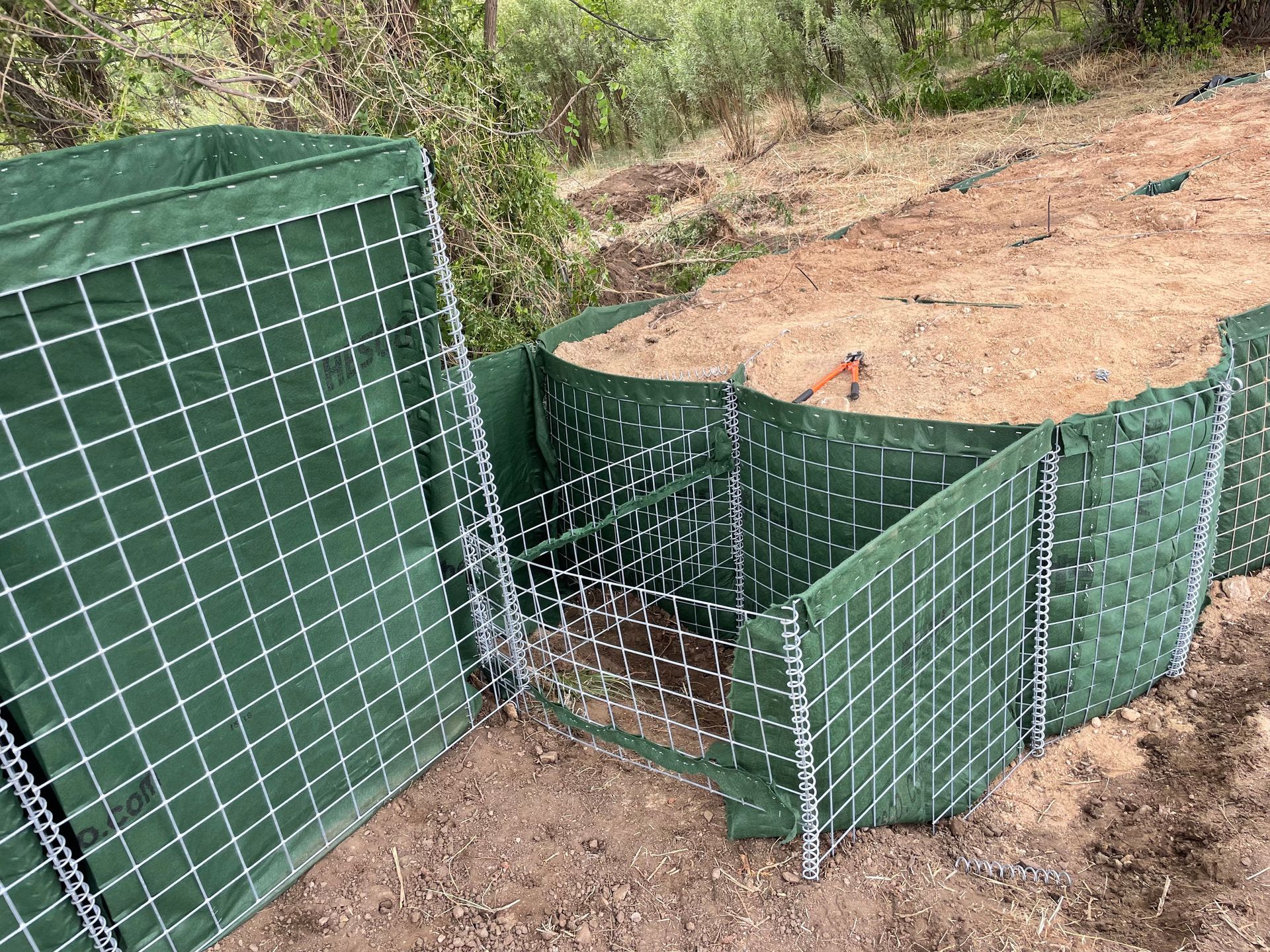 Modified HESCO Bastion goes up an embankment and ties into another row of flood barriers. 
